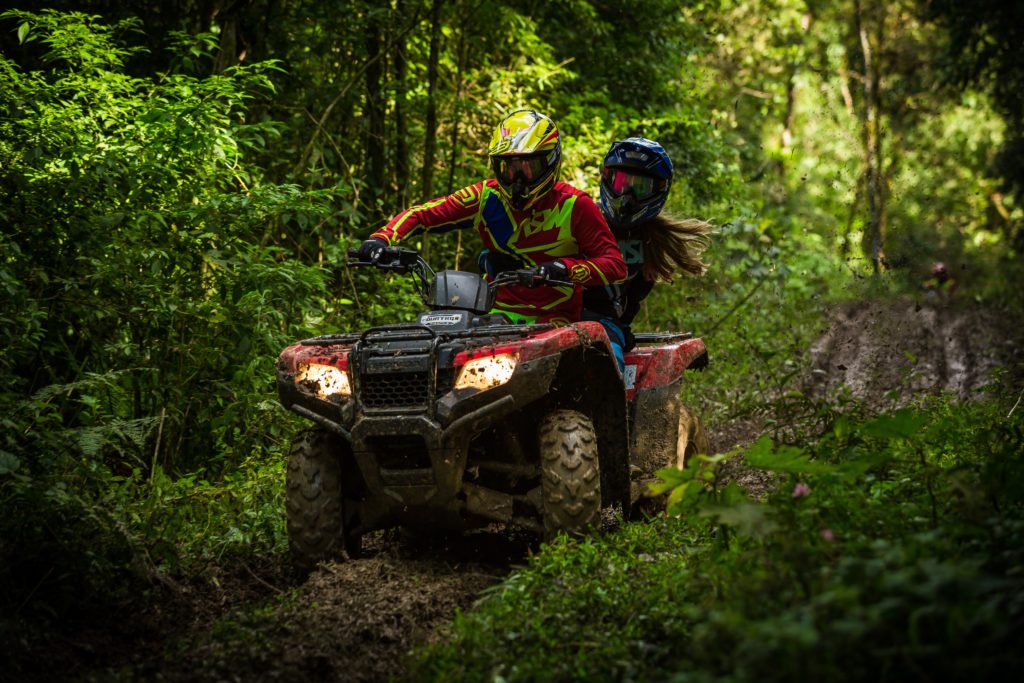 Credit: Elievan Junior. ATV in forest with two riders